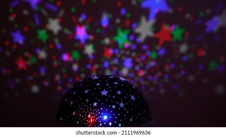 Kids Projector Reflects Moving Colorful Stars On The Wall Creating Psychedelic Night Sky Effect - Colorful Night Background With Stars In The Sky - Disco Light 