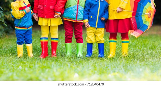 Kids In Rain Boots. Group Of Kindergarten Children In Colorful Rubber Boots And Autumn Jackets. Footwear For Rainy Fall. Foot Wear For Child And Baby. Toddler In Wellies. Rainbow Gumboots. Kid Fashion