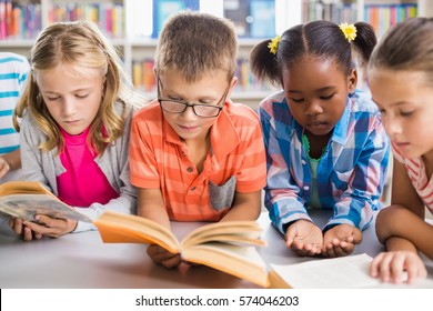 Kids reading a book in library at school