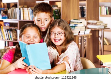 Kids Reading Book In A School Library