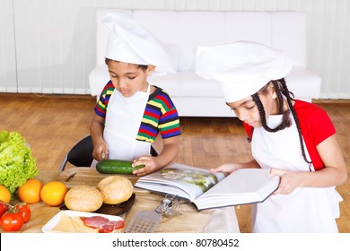 Kids Reading Cook Book And Making Salad