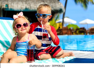 Kids Relax On Tropical Beach Resort And Drink Juices, Family Vacation