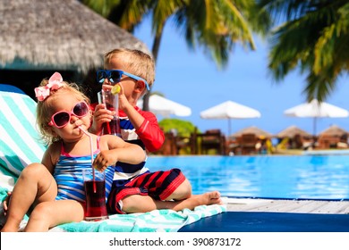 kids relax on tropical beach resort and drink juices - Shutterstock ID 390873172