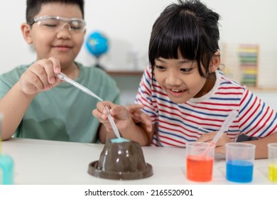 Kids Repeating And Observing A Science Lab Project At Home - The Baking Soda And Vinegar Volcano