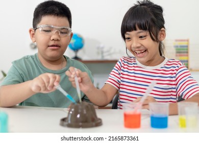 Kids Repeating And Observing A Science Lab Project At Home - The Baking Soda And Vinegar Volcano