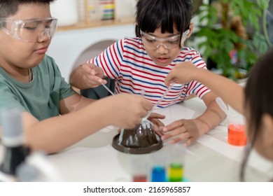 Kids Repeating And Observing A Science Lab Project At Home - The Baking Soda And Vinegar Volcano