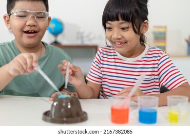 Kids Repeating And Observing A Science Lab Project At Home - The Baking Soda And Vinegar Volcano