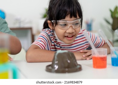 Kids Repeating And Observing A Science Lab Project At Home - The Baking Soda And Vinegar Volcano