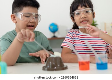 Kids Repeating And Observing A Science Lab Project At Home - The Baking Soda And Vinegar Volcano