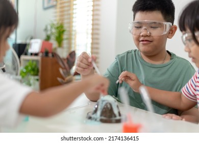 Kids Repeating And Observing A Science Lab Project At Home - The Baking Soda And Vinegar Volcano