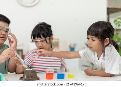 Kids Repeating And Observing A Science Lab Project At Home - The Baking Soda And Vinegar Volcano