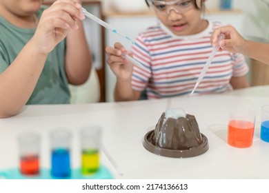 Kids Repeating And Observing A Science Lab Project At Home - The Baking Soda And Vinegar Volcano