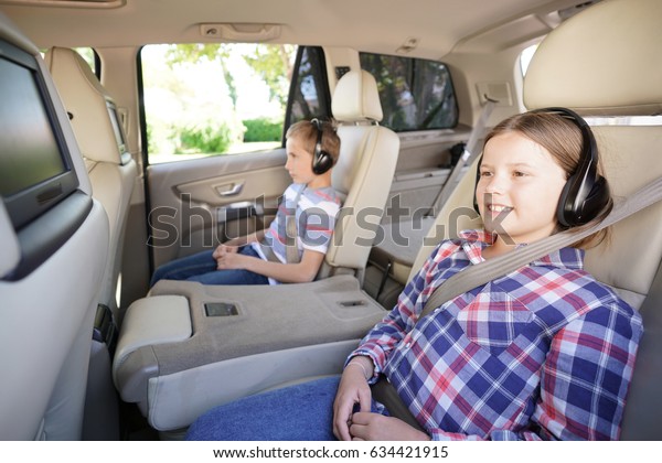 Kids riding car and\
watching movies