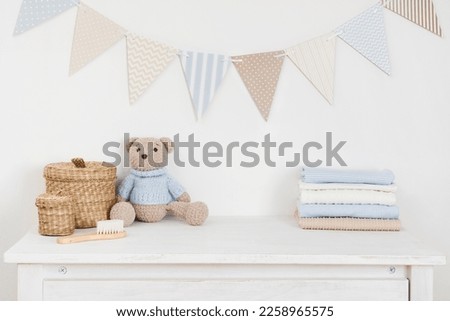 Kids room decorated wall background and sideboard with baby goods