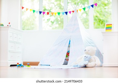 Kids Room With Teepee Tent. Children Play In White Sunny Bedroom. Cozy Light Interior For Kid Nursery Or Playroom. Little Boy With Toy Blocks And Dinosaur Playing On Wooden Floor. Home Decoration.