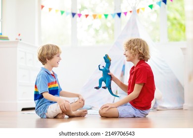 Kids Room With Teepee Tent. Children Play In White Sunny Bedroom. Cozy Light Interior For Kid Nursery Or Playroom. Little Boy With Toy Blocks And Dinosaur Playing On Wooden Floor. Home Decoration.