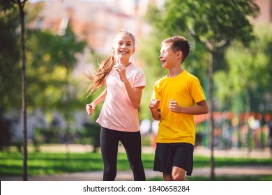 Kids Run. Healthy Sport. Child Sport, Heterosexual Twins Running On Track, Fitness. Joint Training. Running Training Outdoor Brother And Sister Pre-teen. Jogging With Friend. Children Athletes.