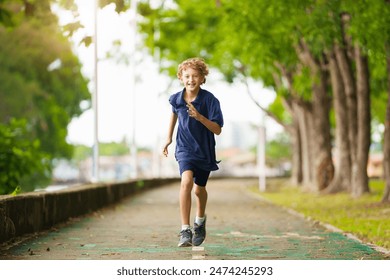 Kids run in summer park. Active child running. Sport for children. School athletics competition. Healthy outdoor activity for kids. - Powered by Shutterstock