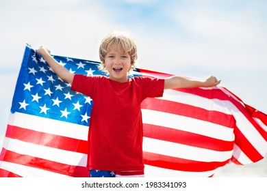 Kids run with USA flag on sunny beach. 4th of July celebration. American family fun on Independence Day weekend. Patriotic children celebrate US holiday. Boy and girl with symbols of America. - Powered by Shutterstock