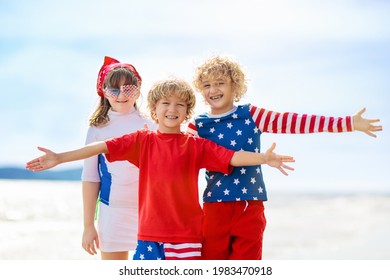 Kids Run With USA Flag On Sunny Beach. 4th Of July Celebration. American Family Fun On Independence Day Weekend. Patriotic Children Celebrate US Holiday. Boy And Girl With Symbols Of America.