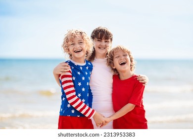 Kids run with USA flag on sunny beach. 4th of July celebration. American family fun on Independence Day weekend. Patriotic children celebrate US holiday. Boy and girl with symbols of America. - Powered by Shutterstock