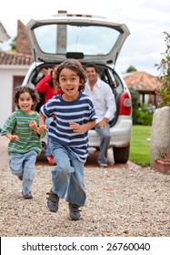 Kids Running Away From A Car And Towards The Camera