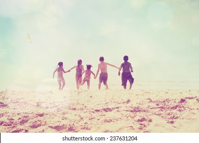 Kids Running At The Beach, Defocused Image.  Focus On Sand. Instagram Effect.