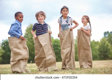 Kids At A Sack Race At The Park In Summer