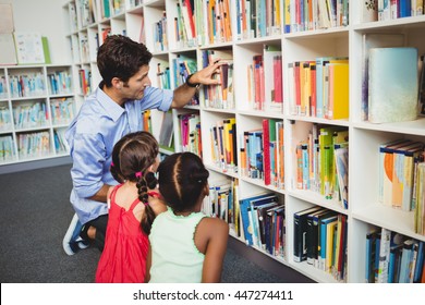 Kids Selecting A Book In A Library