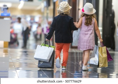 Kids shopping. cute little girl and boy on shopping. portrait of kids with shopping bags. 