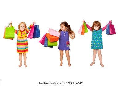 Kids Shopping. Group Of Happy Little Fashion Girls With Shopping Bags. Isolated On White Background