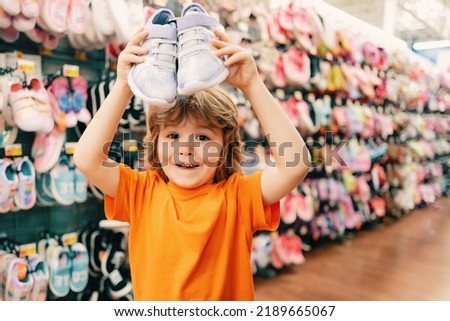 Kids shopping. Sale, consumerism and people concept. Kids shoes store in supermarket, choosing kids in shoes store. Shoes store for kids.