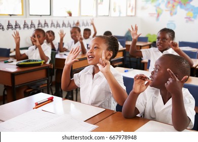 Kids showing hands during a lesson at an elementary school