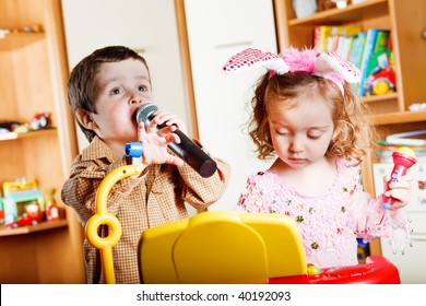 Kids Singing And Playing A Toy Piano