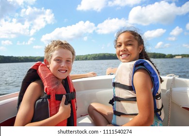 Kids Sitting In A Boat On The Lake