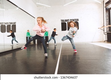 The Kids Sitting At Dance School. Ballet, Hiphop, Street, Funky And Modern Dancers Concept. Studio Background. Teens In Hip Hop Style. Sport, Fitness And Lifestyle Concept.