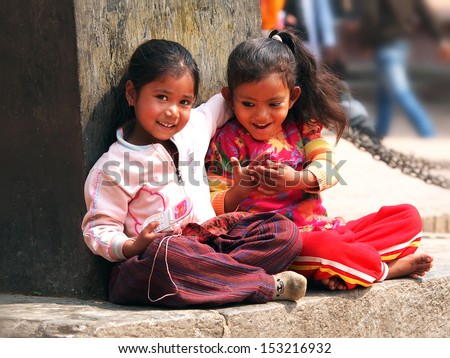Kids sitting on the street of Kathmandu Nepal      