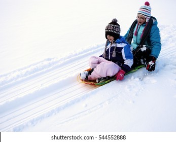 Kids Sledding Down Snowy Hill On Sled Fast Speed