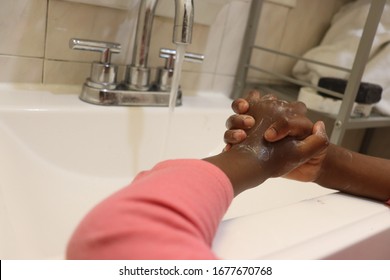 Kids Soapy Hands On Sink With Running Water