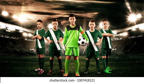 Kids - Soccer Champions. Boys In Football Sportswear On Stadium With Ball. Sport Concept With Soccer Team.