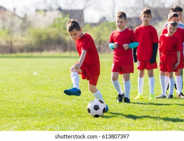 Kids soccer football - small children players exercising before match on soccer field 