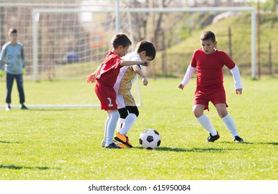Kids soccer football - young children players match on soccer field 