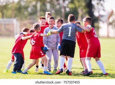 Kids Soccer Football - Young Children Players Celebrating In Hug After Victory