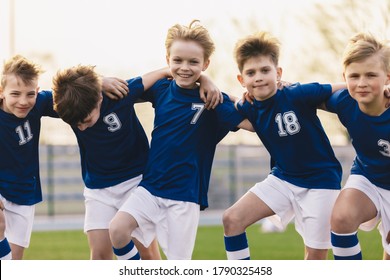 Kids soccer players celebrate a winning in school sports tournament. Happy boys in a football team