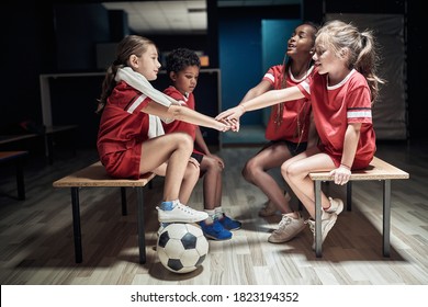 Kid's soccer team building up togetherness in a locker room - Powered by Shutterstock