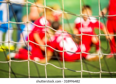 Kids soccer team celebrate goal and victory, defocussed blur sport background image - Powered by Shutterstock