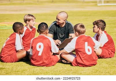 kids, soccer and team coach planning training with clipboard on soccer field for sport competitiion together. Athlete children, teamwork and sit on grass before football match or workout outdoors - Powered by Shutterstock