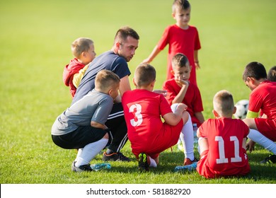 Kids Soccer Waiting In A Out With Coach