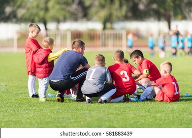 Kids Soccer Waiting In A Out With Coach