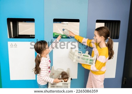 Kids sorting plastic by polymer type and taking out plastic trash in recycling centre. Sustainble lifestyle concept. National recycling week.